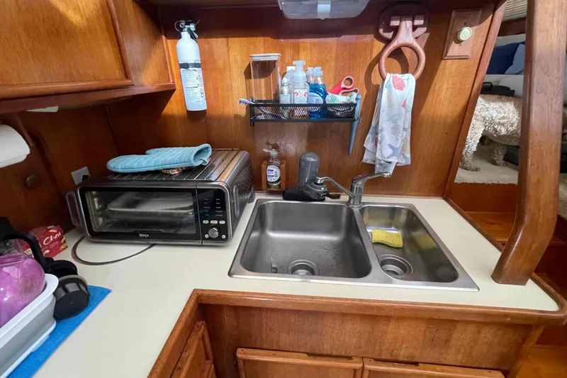 Slide: The Image of Cozy interior of 1987 Chris-Craft 426 Catalina yacht with plush seating and TV. - 6