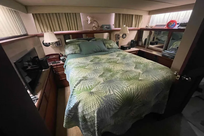 Slide: The Image of 1987 Chris-Craft 426 Catalina kitchen with stove, microwave, sink, and wooden cabinetry. - 9