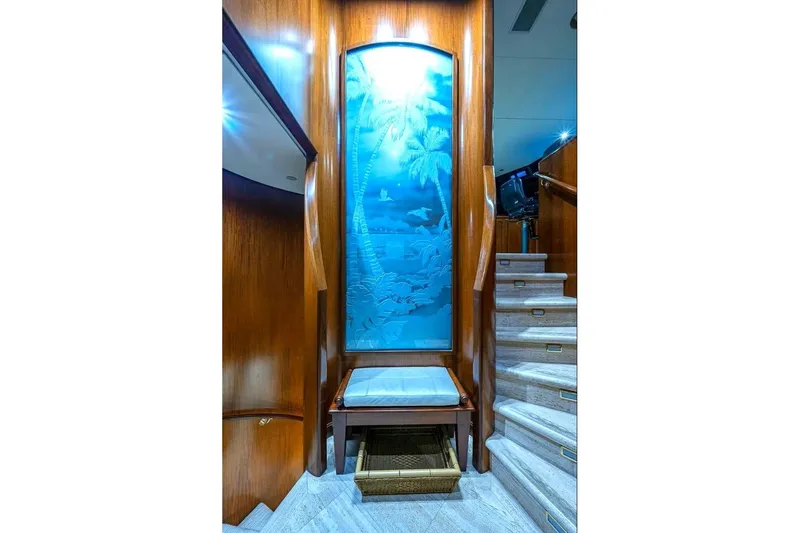 Slide: The Image of Luxurious Christensen Raised Pilothouse yacht interior with elegant wood paneling and decorative glass art. - 10