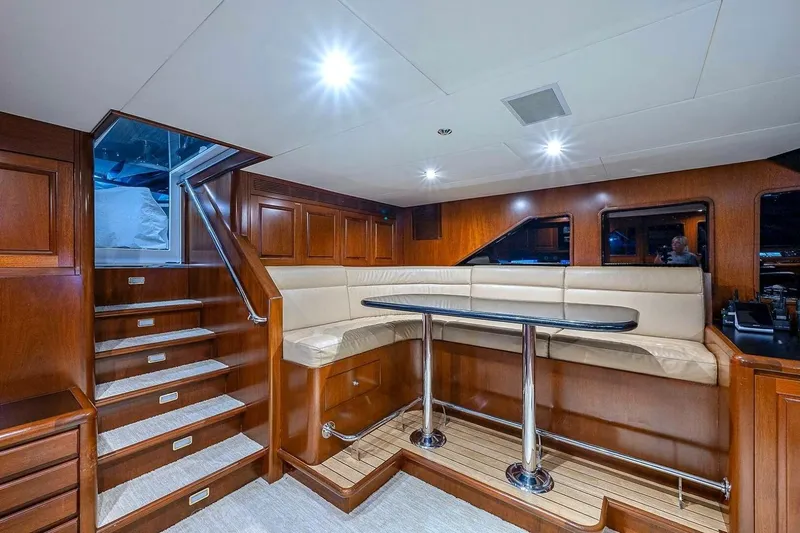 Slide: The Image of Luxurious interior of 2000 Christensen Raised Pilothouse yacht with wood paneling and plush seating. - 11