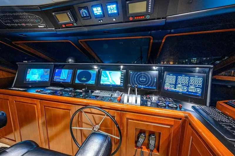 Slide: The Image of Luxurious 2000 Christensen Raised Pilothouse yacht cockpit with advanced navigation systems and controls. - 13