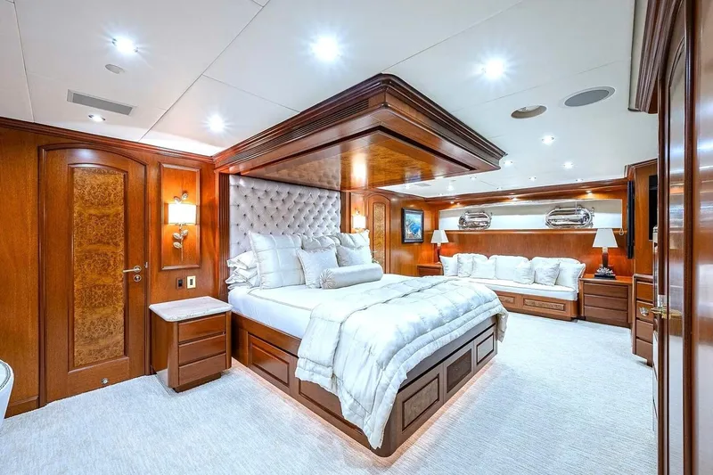 Slide: The Image of Luxurious bedroom interior on 2000 Christensen Raised Pilothouse yacht, featuring elegant wood finishes. - 14