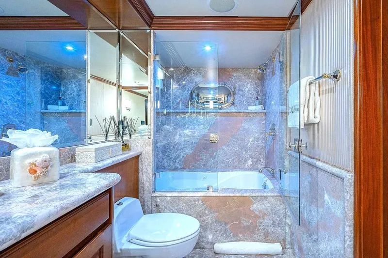 Slide: The Image of Luxurious yacht bathroom with marble decor, glass shower, and elegant fixtures on Christensen Raised Pilothouse. - 18