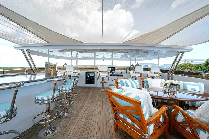 Slide: The Image of Luxurious 2000 Christensen Raised Pilothouse yacht deck with elegant seating and bar area. - 24