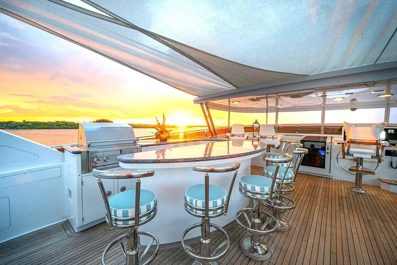Slide: The Image of Luxurious 2000 Christensen Raised Pilothouse yacht deck with bar, sunset view. - 26