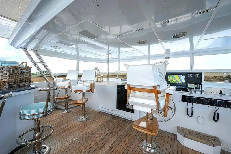 Slide: The Image of Luxurious 2000 Christensen Raised Pilothouse yacht interior with helm and seating. - 27