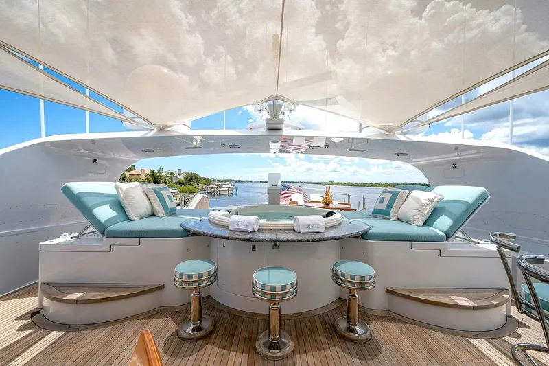 Slide: The Image of Luxurious 2000 Christensen Raised Pilothouse yacht deck with plush seating and scenic water view. - 28