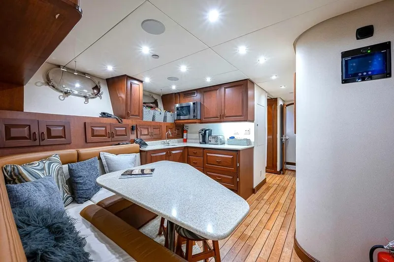 Slide: The Image of Luxurious 2000 Christensen Raised Pilothouse yacht interior with modern kitchen and cozy seating area. - 32