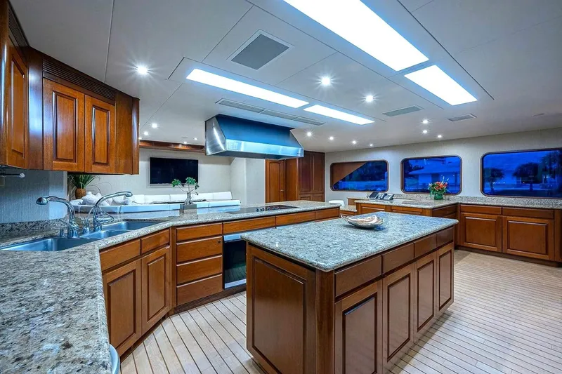 Slide: The Image of Luxurious kitchen interior on 2000 Christensen Raised Pilothouse yacht with wooden cabinetry and granite countertops. - 8