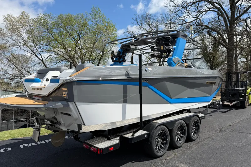 Slide: The Image of 2026 Nautique Super Air Nautique G25 boat on trailer, parked outdoors. - 8