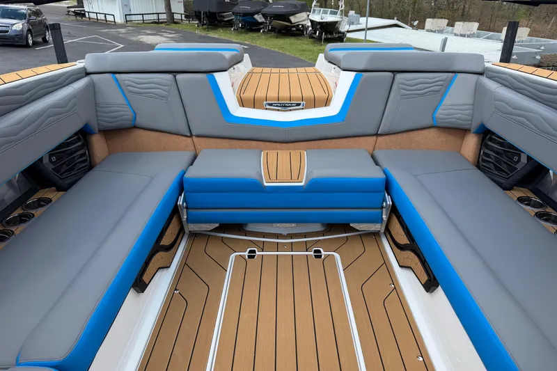 Slide: The Image of Interior of 2026 Nautique Super Air Nautique G25 boat with gray and blue seating. - 17