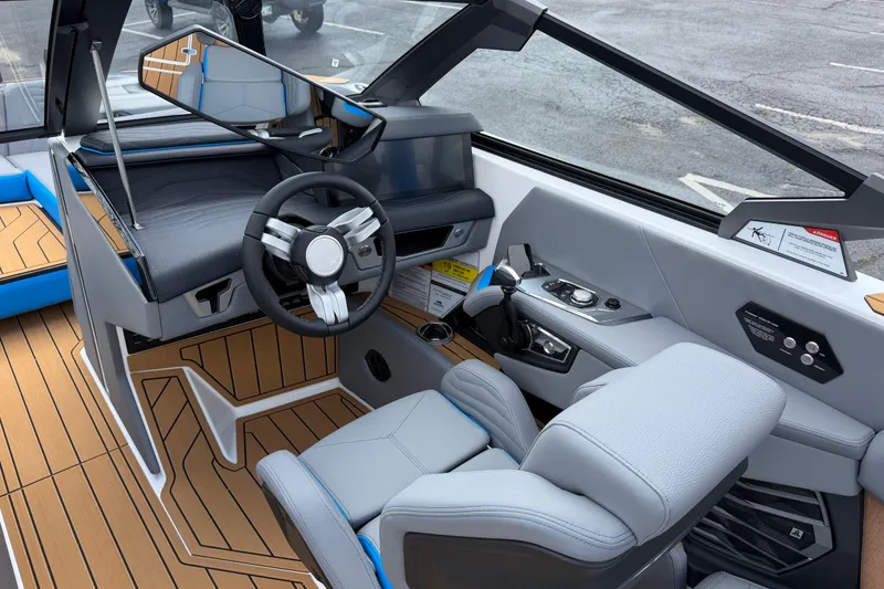 Slide: The Image of Interior of 2026 Nautique Super Air Nautique G25 boat, featuring modern helm and controls. - 19