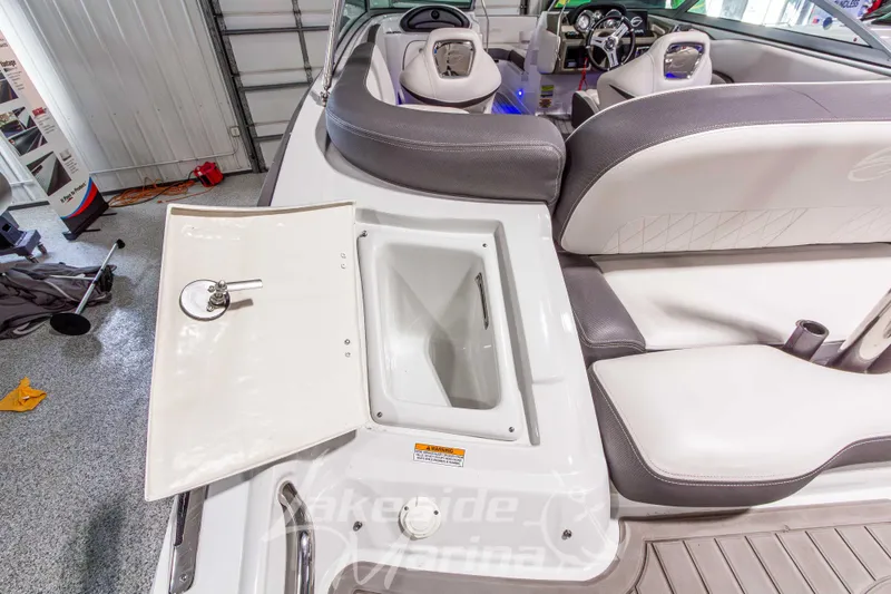 Slide: The Image of 2017 Crownline Eclipse E1 XS boat interior with open storage compartment and seating. - 10