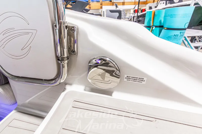 Slide: The Image of 2017 Crownline Eclipse E1 XS boat interior detail with stainless steel fittings and safety notice. - 11