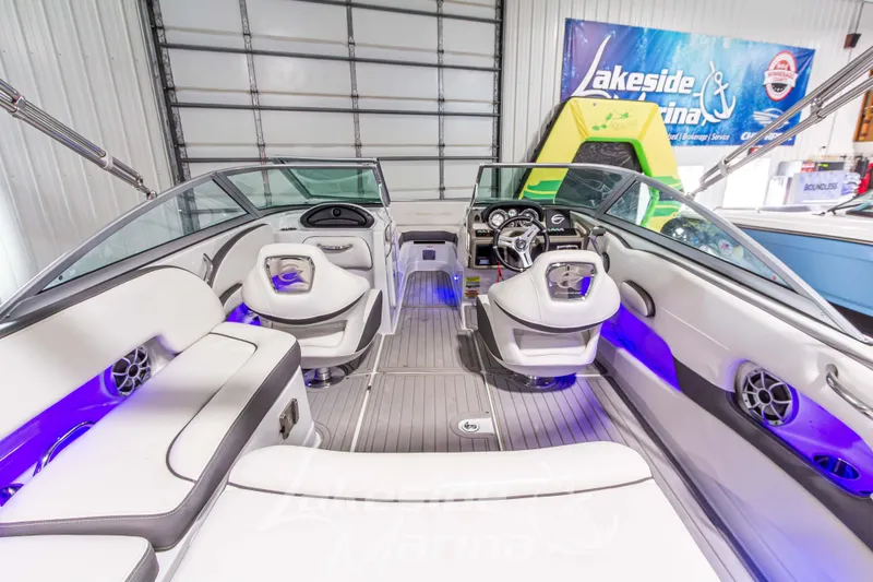 Slide: The Image of 2017 Crownline Eclipse E1 XS boat interior with modern seating and blue LED lighting. - 14
