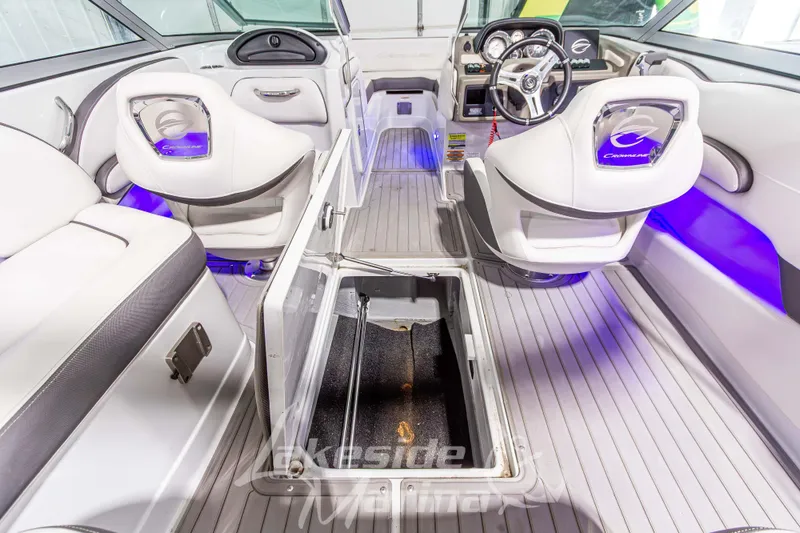 Slide: The Image of 2017 Crownline Eclipse E1 XS boat interior with open storage compartment and illuminated seating. - 18