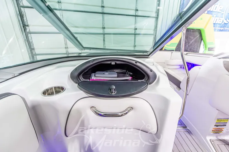Slide: The Image of 2017 Crownline Eclipse E1 XS boat interior with storage compartment and cup holder. - 25