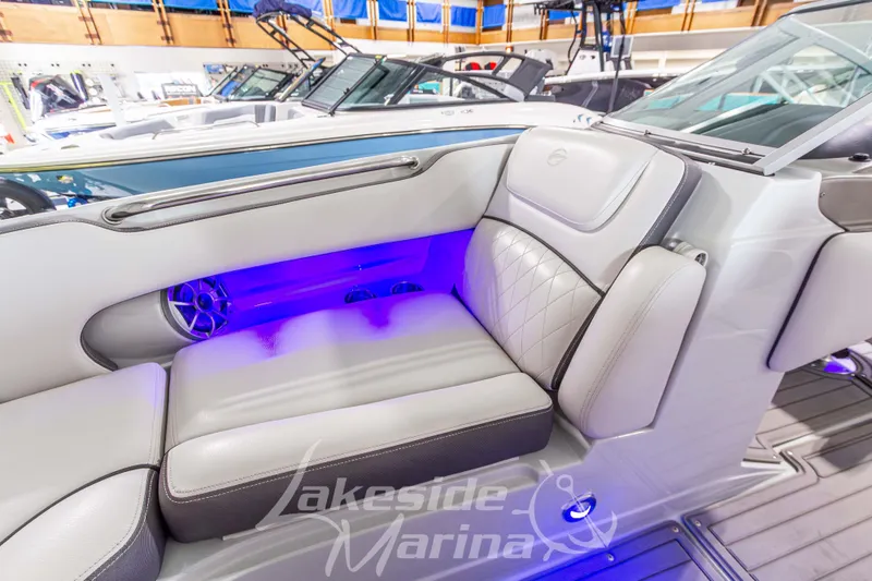 Slide: The Image of 2017 Crownline Eclipse E1 XS boat interior with luxurious seating and ambient blue lighting. - 31