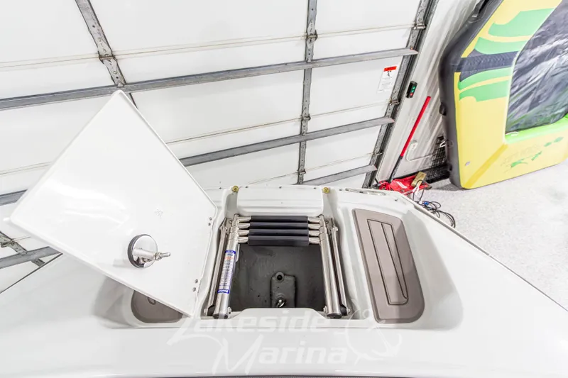Slide: The Image of 2017 Crownline Eclipse E1 XS boat storage compartment with open hatch in a garage setting. - 35