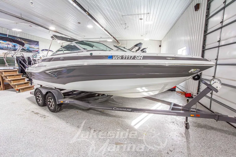 Slide: The Image of 2017 Crownline Eclipse E1 XS boat on trailer in indoor showroom. - 7