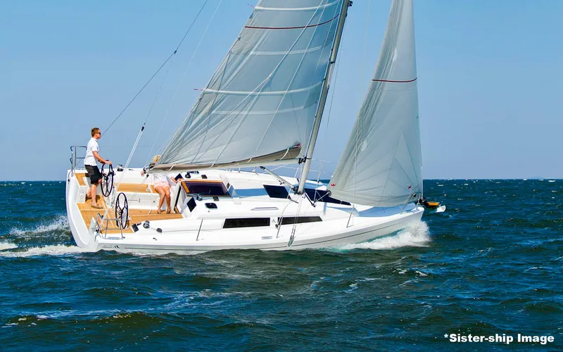 Slide: The Image of 2018 Hanse 315 sailboat navigating open waters with full sails. - 1