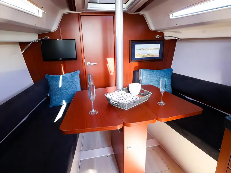 Slide: The Image of Interior of 2018 Hanse 315 yacht with cozy seating and elegant table setting. - 15
