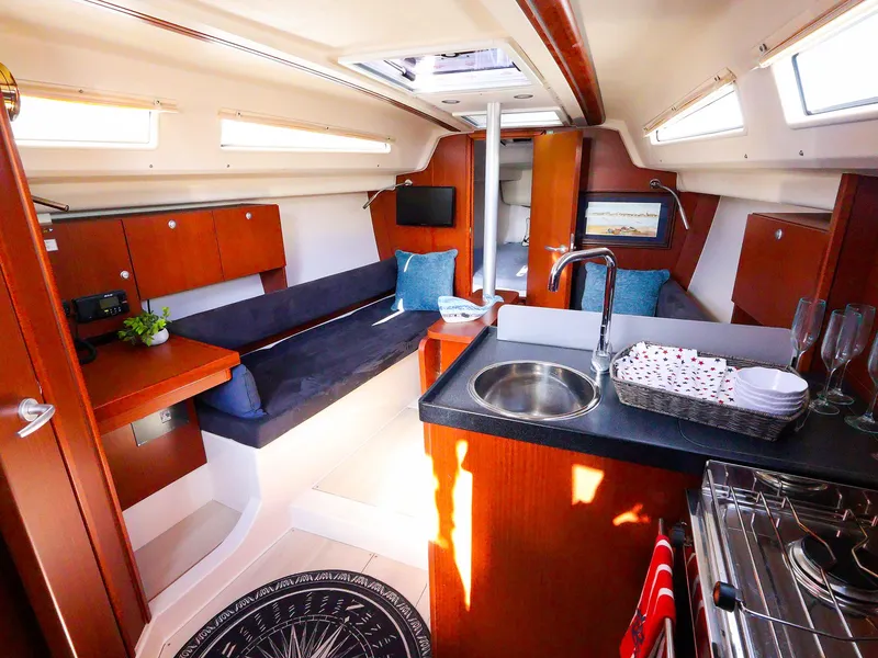 Slide: The Image of Interior of 2018 Hanse 315 yacht with modern kitchen and cozy seating area. - 18