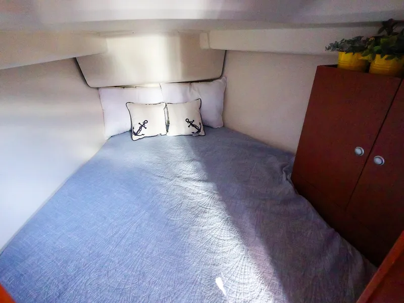 Slide: The Image of Cozy cabin interior of 2018 Hanse 315 yacht with nautical-themed pillows. - 23