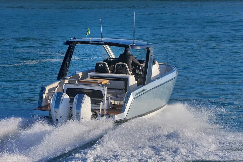 Slide: The Image of Schaefer V34 2027 motorboat cruising swiftly on the water. - 2