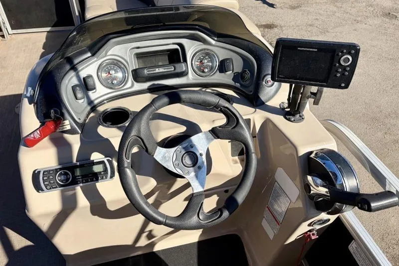 Slide: The Image of 2019 Sun Tracker Party Barge 22 DLX dashboard with steering wheel and navigation equipment. - 3