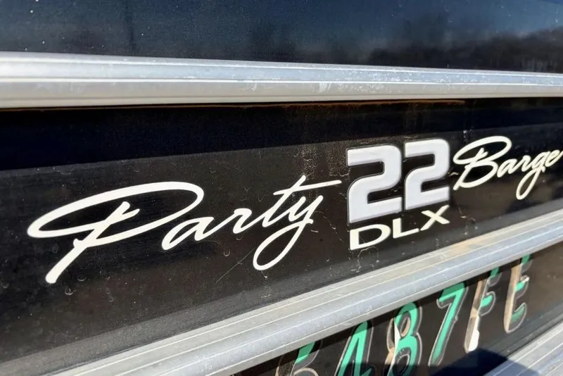 Slide: The Image of 2019 Sun Tracker Party Barge 22 DLX logo on black surface. - 5