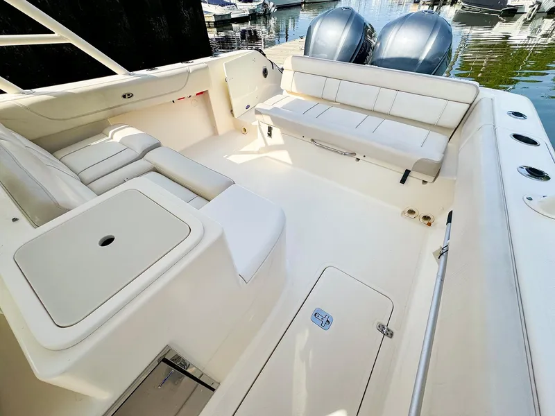 Slide: The Image of 2014 Pursuit ST 310 Sport boat interior with seating and storage compartments. - 12