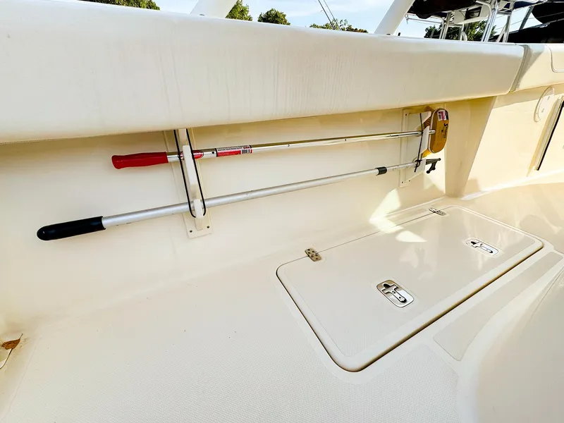 Slide: The Image of 2014 Pursuit ST 310 Sport boat interior with storage compartment and mounted tools. - 15