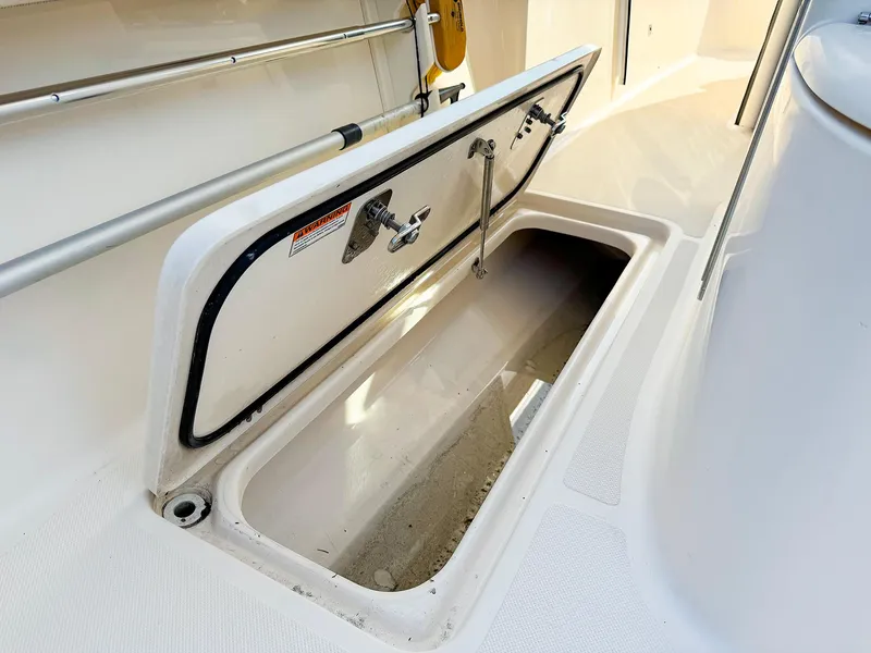 Slide: The Image of Open storage compartment on 2014 Pursuit ST 310 Sport boat deck. - 16