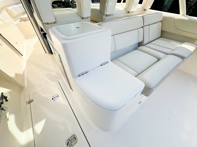 Slide: The Image of 2014 Pursuit ST 310 Sport boat interior with white cushioned seating. - 19