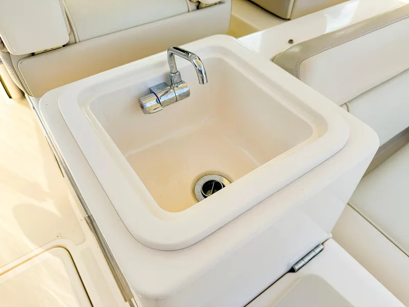 Slide: The Image of 2014 Pursuit ST 310 Sport boat sink with chrome faucet. - 21