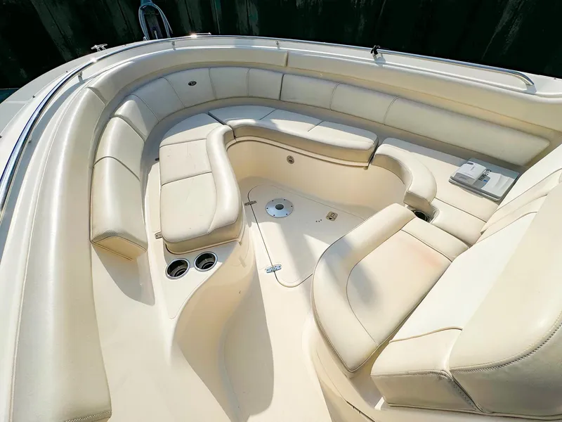 Slide: The Image of 2014 Pursuit ST 310 Sport boat interior with beige seating and cup holders. - 29