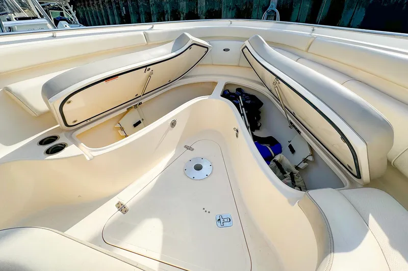Slide: The Image of 2014 Pursuit ST 310 Sport boat interior with open storage compartments. - 31