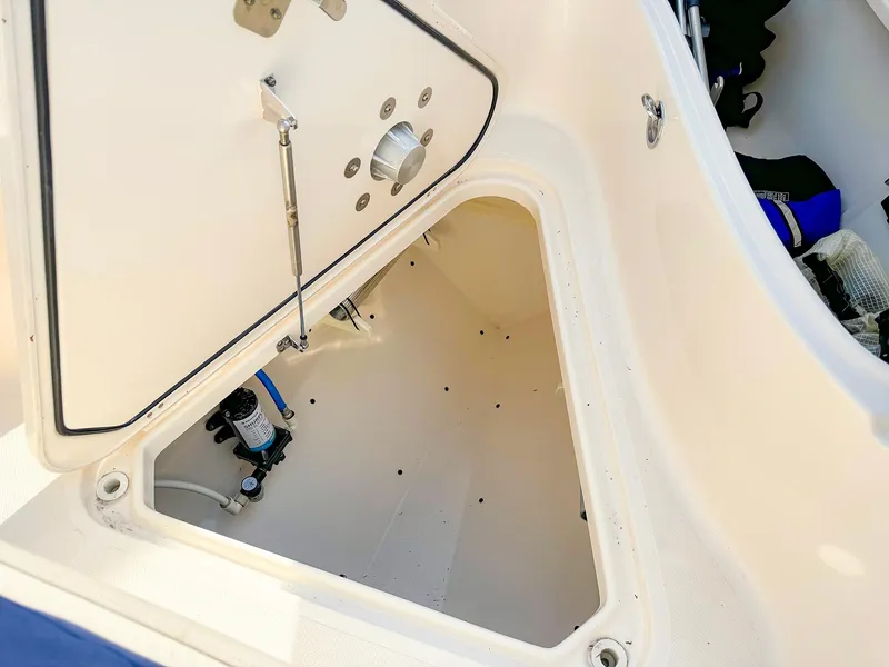 Slide: The Image of Open storage compartment on 2014 Pursuit ST 310 Sport boat. - 32