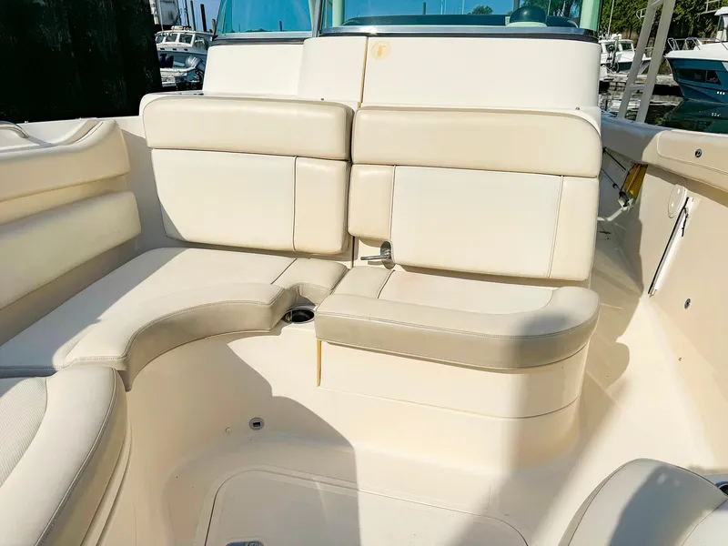 Slide: The Image of 2014 Pursuit ST 310 Sport boat interior with beige seating. - 33