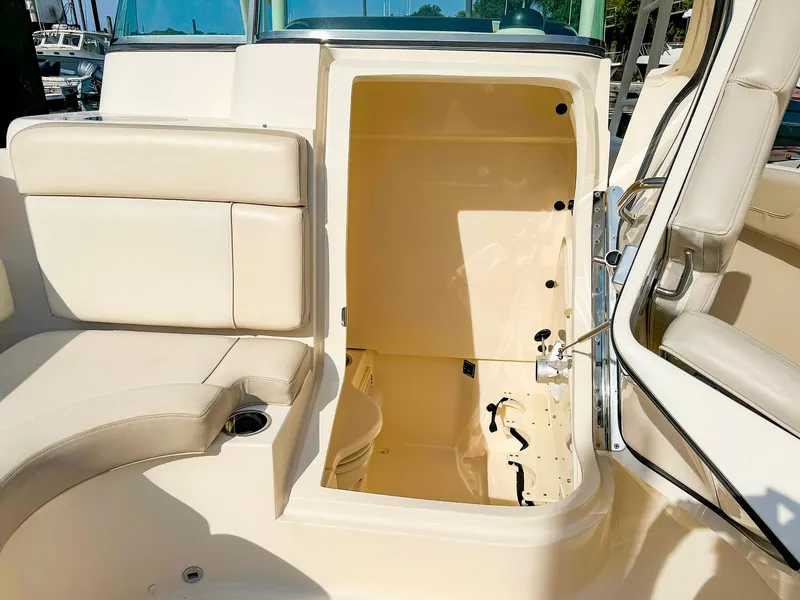 Slide: The Image of 2014 Pursuit ST 310 Sport boat interior with open storage compartment. - 34