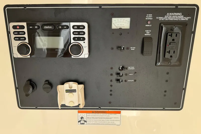 Slide: The Image of Control panel of a 2014 Pursuit ST 310 Sport boat with various switches and outlets. - 37