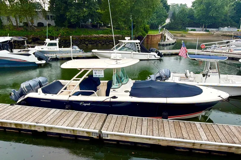 The Image of 2014 Pursuit ST 310 Sport boat docked, covered, and for sale in a marina. - 0