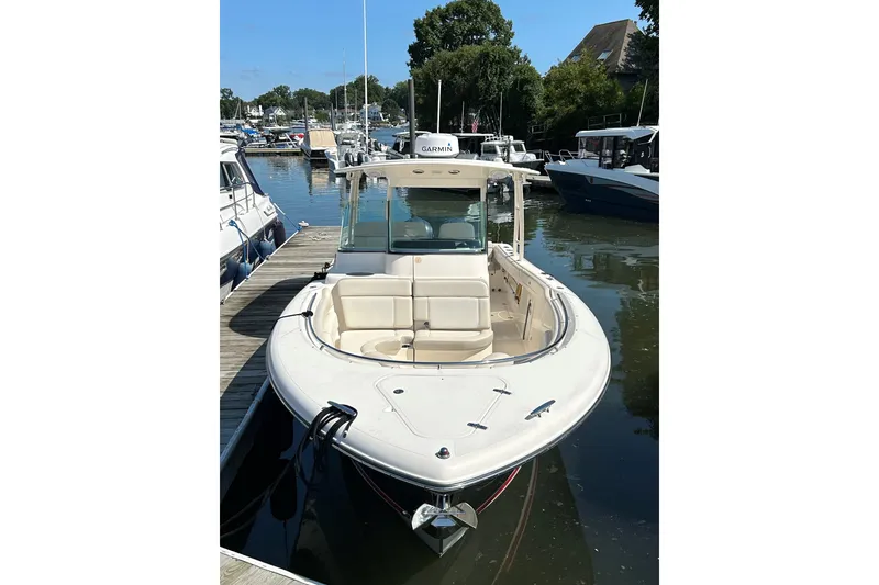 Slide: The Image of 2014 Pursuit ST 310 Sport boat docked at marina, front view. - 5