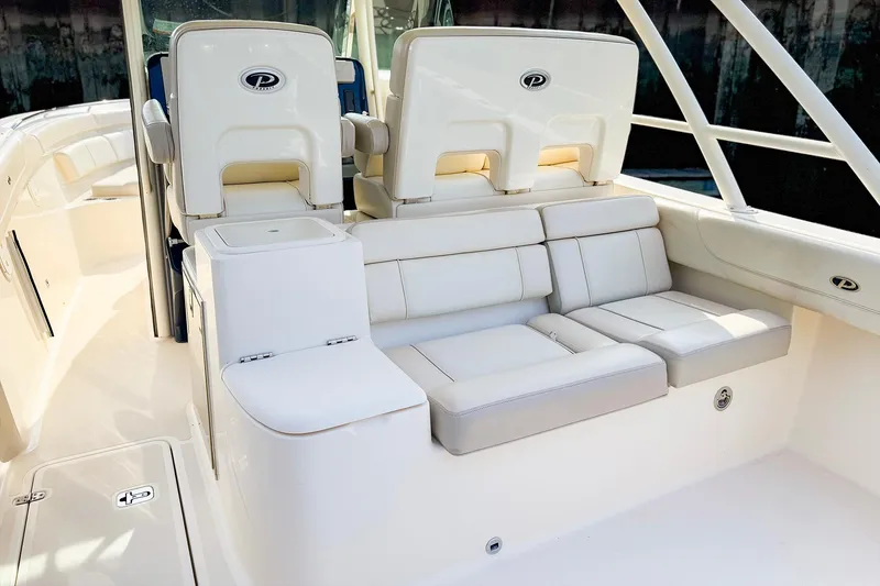 Slide: The Image of 2014 Pursuit ST 310 Sport boat interior with white seating and sleek design. - 9