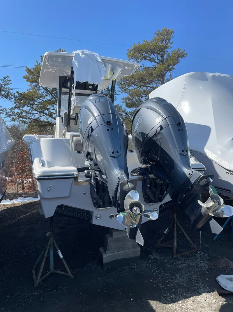 Slide: The Image of 2026 Key West 260 CC with dual outboard motors on stands. - 14