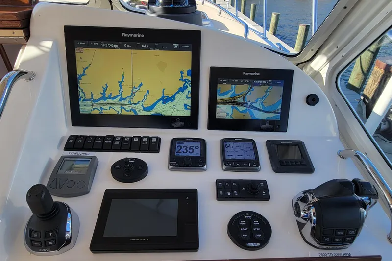 Slide: The Image of Control panel of a 2017 MJM 40z Downeast boat with navigation screens and controls. - 16