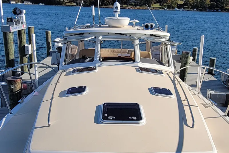 Slide: The Image of 2017 MJM 40z Downeast yacht docked at marina, showcasing sleek design and spacious deck. - 7