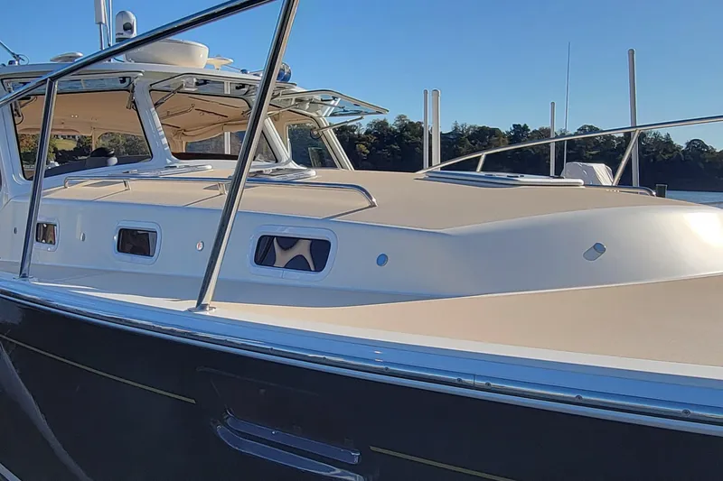 Slide: The Image of 2017 MJM 40z Downeast boat with sleek design and modern features on a sunny day. - 8