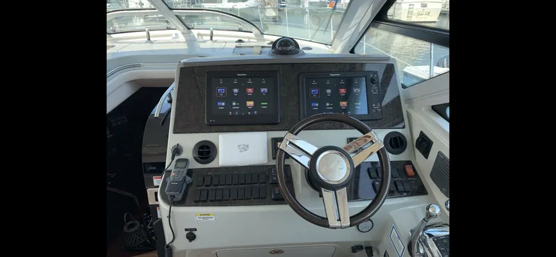 Slide: The Image of 2010 Sea Ray 470 Sundancer helm with modern controls. - 11